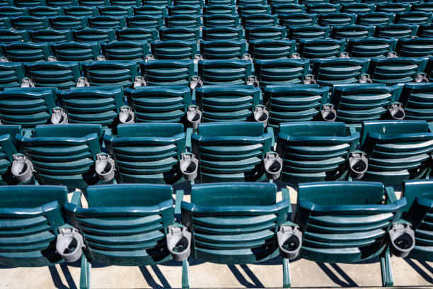 Stadium seats summertime Empty plastic seats in baseball stadium before games start in the summertime baseball stadium chairs stock pictures, royalty-free photos & images