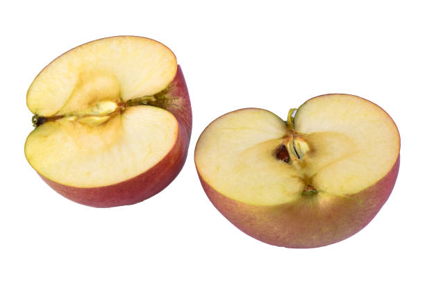 istock Two halves of fresh apple isolated on white 1137794903