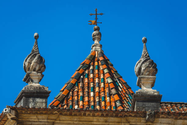 istock metal cross on the tiled roof 1137796575