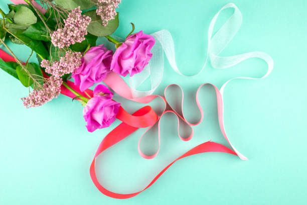 istock Three pink roses on a green background. Copy space. 1137797229
