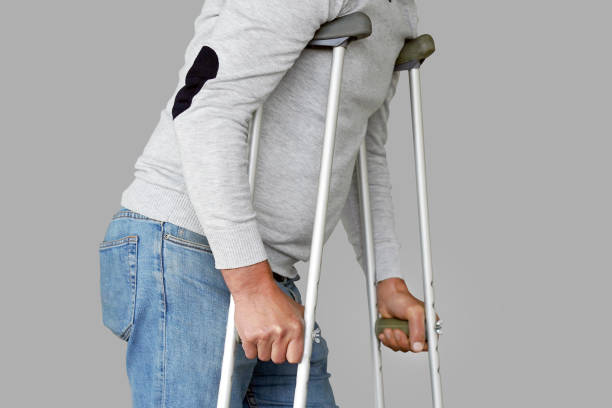 istock Man with crutch. Close-up. Side view 1137797572
