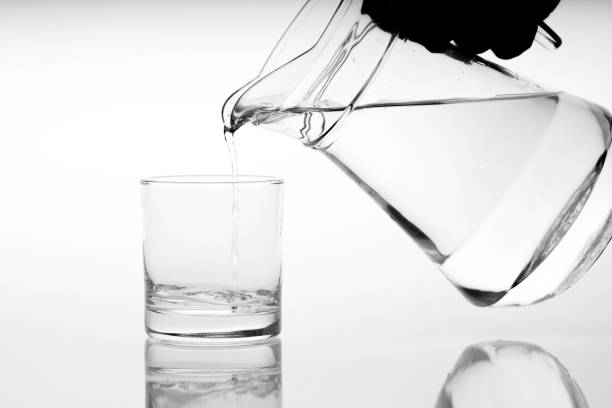 istock Close up pouring drinking water into glass, studio shot 1137797648