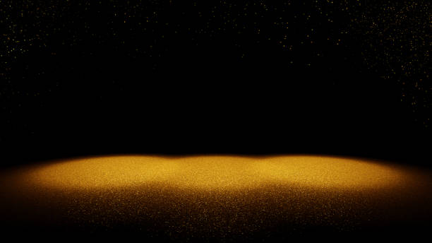 istock shiny glitter background - twinkling golden glitter falling on a stage lit by three bright spotlights 1137801899