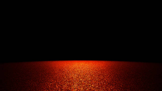 istock twinkling golden and red glitter on a flat surface lit by a bright spotlight (on black background) 1137801906