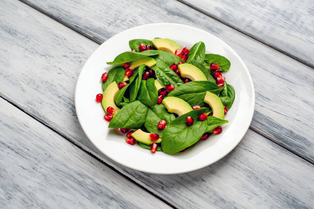 istock salad with avocado, arugula, spinach, pomegranate, seeds on wooden background 1137804701