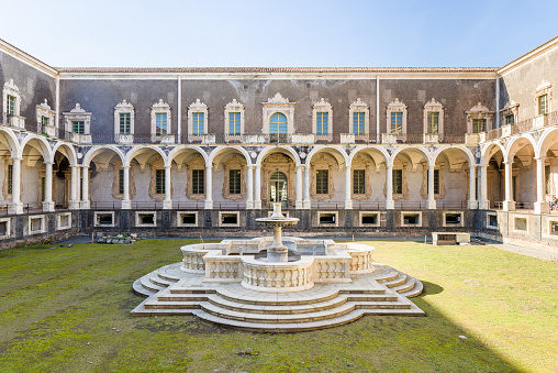Baroque central courtyard with colonnade in the Benedictine closter now part of Università dei Benedettini, Catania, Sicily, Italy.