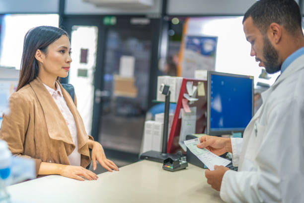 istock Young pharmacist looking in medical prescription 1137809113