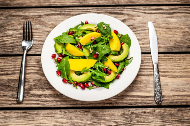 istock salad with avocado, arugula, spinach, pomegranate, seeds on wooden background 1137809175