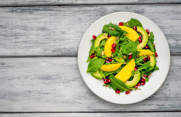 istock salad with avocado, arugula, spinach, pomegranate, seeds on wooden background 1137809270