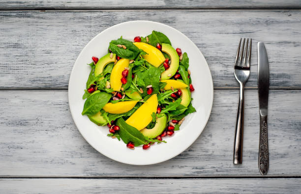 istock salad with avocado, arugula, spinach, pomegranate, seeds on wooden background 1137809424