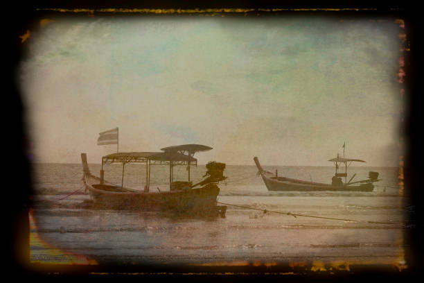 Longtail boat moored off the beach at Pakarang, Thailand. The image has been post processed to give an 18th century treasure map effect.