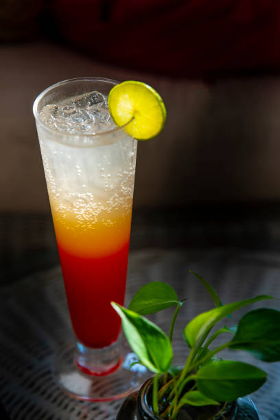 istock Tequila sunrise cocktail back lit against a tropical sky 1137810877