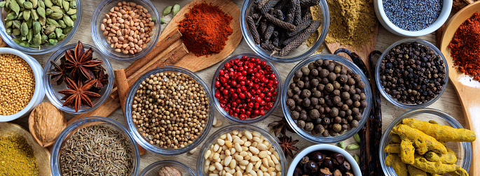 Spices and herbs. Colorful spices flat lay on wooden table, banner