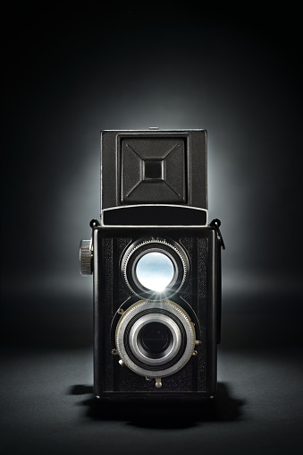 Old fashion twin-lens medium format camera on the black background.