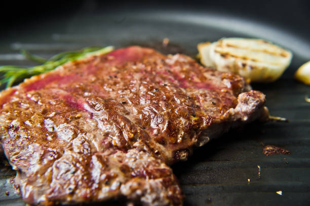 istock Beef BBQ steak in the pan. Dark background, side view, selective focus 1137814744