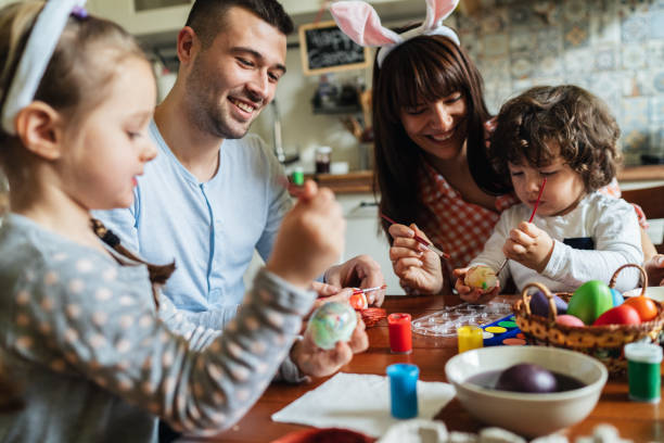 istock Happy family painting Easter eggs 1137814886
