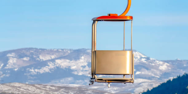 istock Sunlit ski lift with mountain and sky background 1137815356