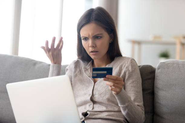 donna sconvolta che usa il servizio di online banking, problema con carta di credito - credit crunch wallet home finances credit card foto e immagini stock