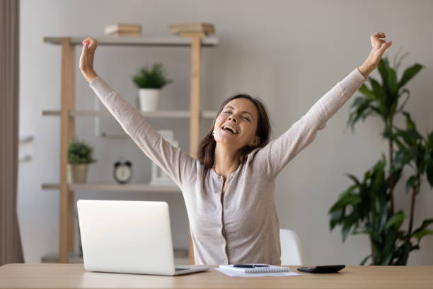 istock Excited smiling woman stretching hands at workplace after finish work 1137821459