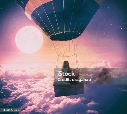 istock Little girl flying over the clouds 1137827942