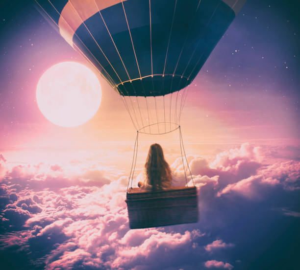 Little girl flying over the clouds Dreamy photo manipulation of little girl flying with a hot air balloon over the clouds, looking at full moon. ethereal stock pictures, royalty-free photos & images