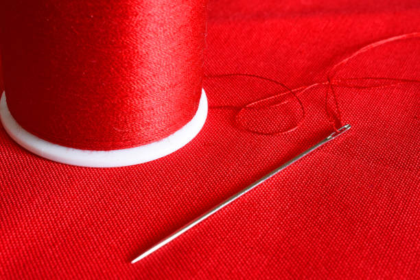 istock Red Thread and Sewing Needle Close Up 1137828860
