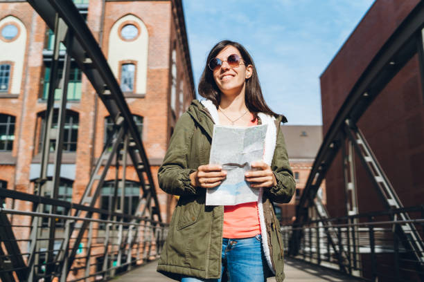 istock Woman exploring Hamburg with a map 1137830494