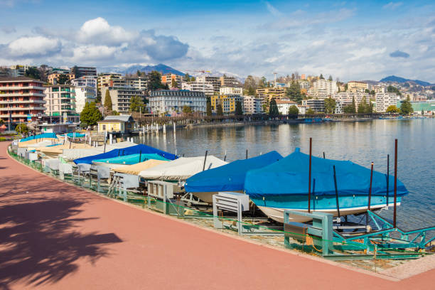 traditional fishing boats in a harbor of lugano lake - ticino canton mountain lake lugano lake imagens e fotografias de stock