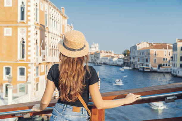 Woman in the Venice, standing on the bridge over the grand canal while on sightseeing in a foreign city. Discovery the Venice adventure. Woman in the Venice, standing on the bridge over the grand canal while on sightseeing in a foreign city. Discovery the Venice adventure. venize stock pictures, royalty-free photos & images