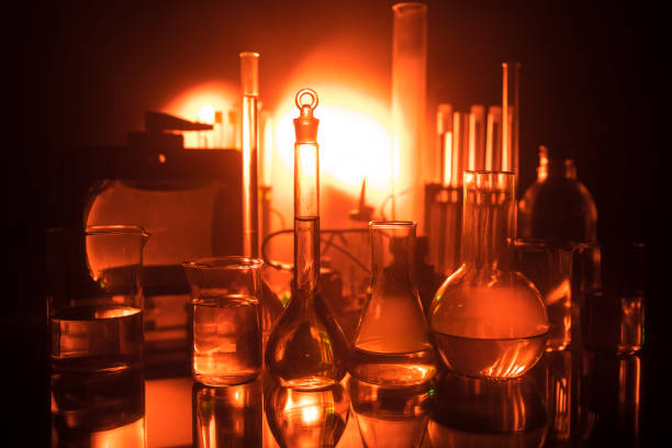 istock Pharmacy and chemistry theme. Test glass flask with solution in research laboratory. Science and medical background. Laboratory test tubes on dark toned background 1137841392