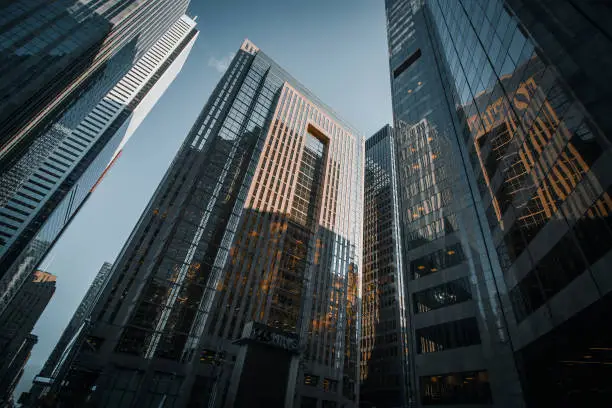 Lookup wide-angle view on glass skyscrapers of Downtown Toronto, where the financial district is