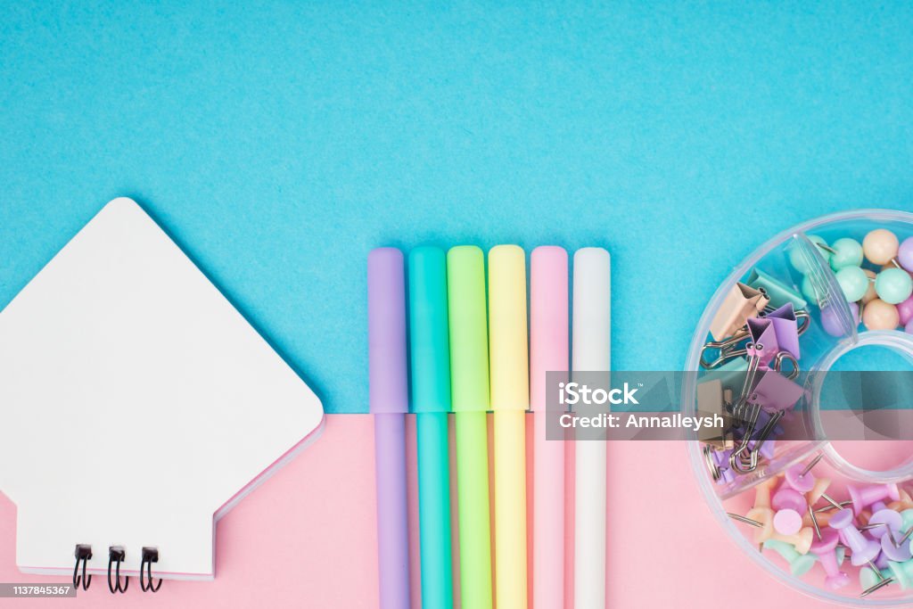 Notebook, pen, paper clips on pastel paper background. Top view. Place for text. Horizontal. Notebook, pen, paper clips on pastel paper background. Top view. Place for text. Horizontal Accessibility Stock Photo