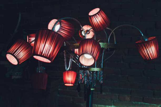 istock Red brown ceiling with adorable chandelier 12 lamps. 1137845561