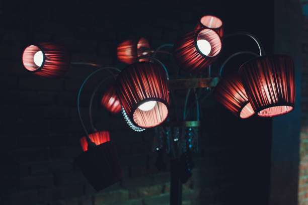 istock Red brown ceiling with adorable chandelier 12 lamps. 1137845568