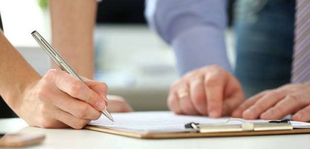 istock Female arm offer contract form on clipboard pad 1137845620