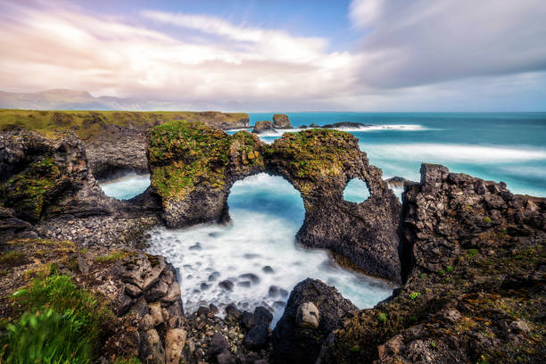 istock Amazing stone arch Gatklettur basalt rock on Atlantic coast of Arnarstapi in Iceland. The famous natural form arch attracts tourist to visit west of Iceland. 1137845708