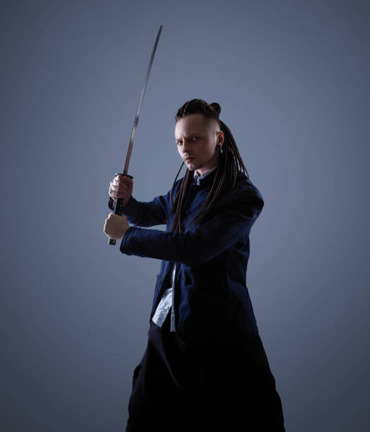 istock Young man holding a samurai sword. Glamour photo. 1137846869
