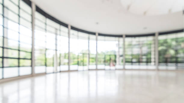 Office building business lobby blur background with blurry glass window transparent wall interior view inside empty entrance hall Blur background interior view looking out toward to empty office lobby and entrance doors and glass curtain wall school receptionist stock pictures, royalty-free photos & images