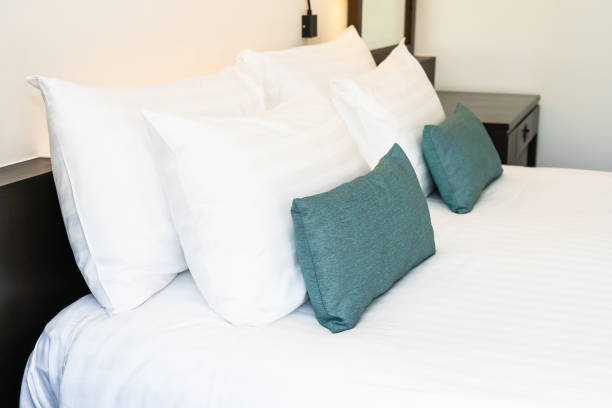 istock Beautiful luxury and comfortable bedroom interior decoration with white pillow blanket light lamp 1137848090