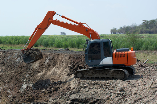 Excavators are working to build ponds for agriculture in rural area.
