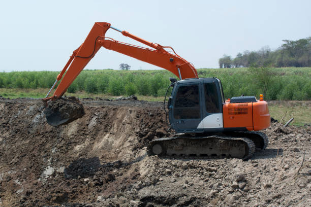 Excavators are working to build ponds for agriculture in rural area. Excavators are working to build ponds for agriculture in rural area. Earthmoving stock pictures, royalty-free photos & images