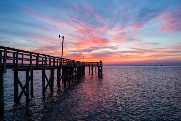 Sunset over Mobile Bay on the Alabama Gulf Coast Sunset over Mobile Bay on the Alabama Gulf Coast mobile bay stock pictures, royalty-free photos & images