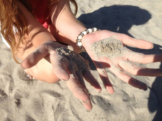 istock Young girl holding sand 1137863079