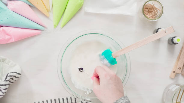 istock Mixing royal icing to decorate Easter sugar cookeis. 1137868523
