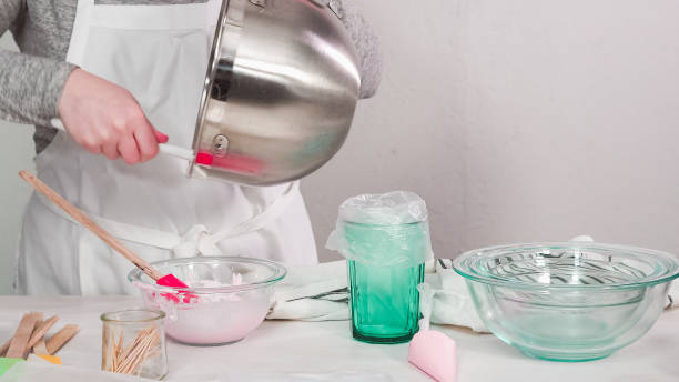 istock Mixing royal icing in electric kitchen mixer for Easter cookies. 1137868550