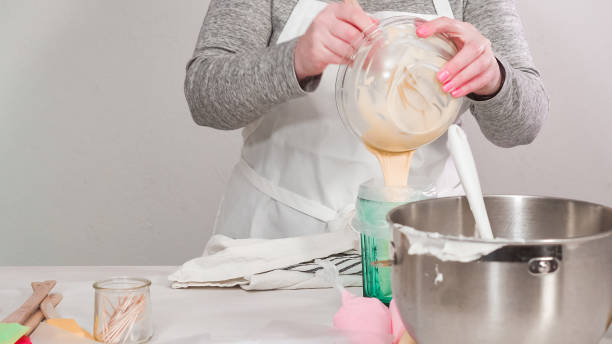 istock Mixing royal icing to decorate Easter sugar cookeis. 1137868632