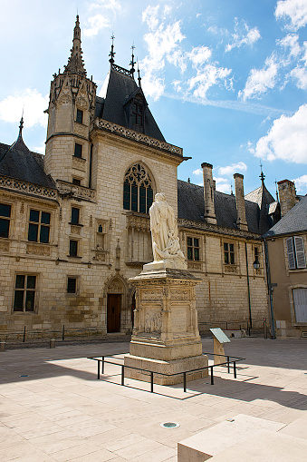 Bourges,France-06 16 2014:The facade of the Jacques Coeur's palace and statue in Bourges,France.Jacques Cœur, was one of the leading merchants in the French trading route network in the 1400s