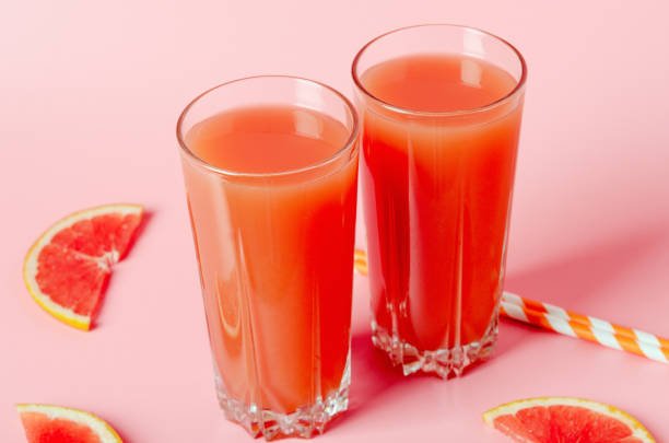 istock Refreshing grapefruit juice with straws on a pink background with grapefruit slices. Summer refreshing diet drink, healthy food 1137876260