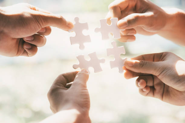 istock Business people group holding jigsaw puzzle. 1137876950