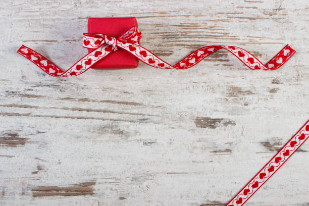 istock Wrapped gift with red ribbon for Valentines Day, copy space for text 1137885144